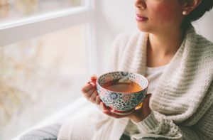 Girl holding cup of tea