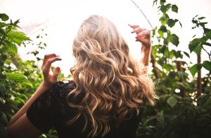 girl with curled hair blowing in the wind