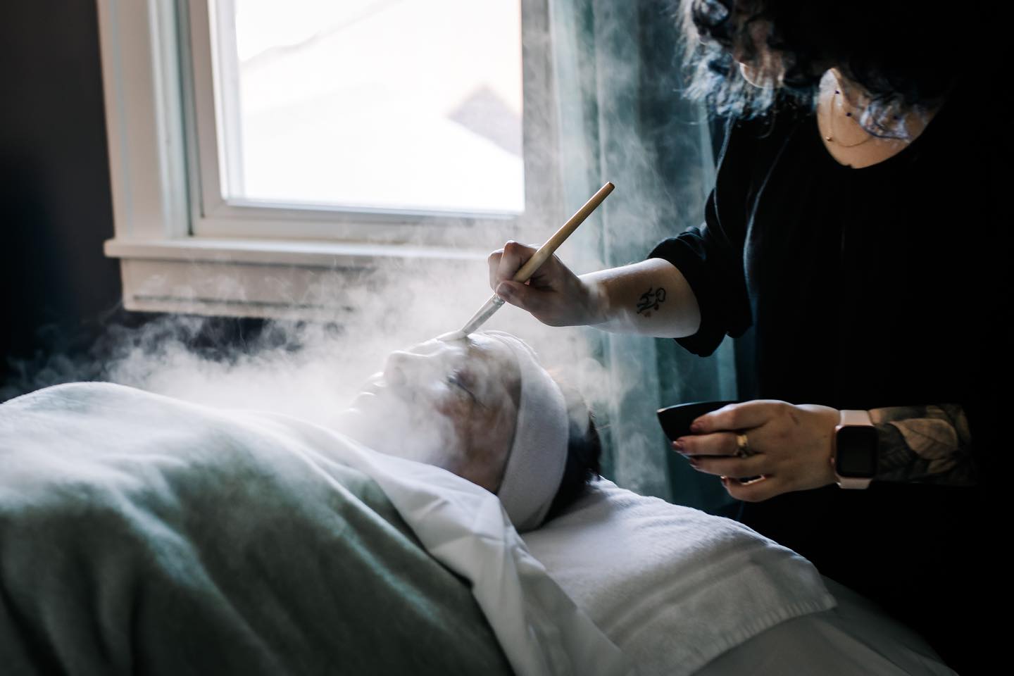 Applying a face mask at Rhimix Salon & Spa